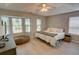 Bright main bedroom featuring hardwood floors, a large bed, and plenty of natural light at 4149 Spring Cove Dr, Duluth, GA 30097
