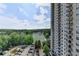 This balcony features a metal railing and a view of a parking lot, park, tennis courts, neighborhood, and apartment building at 795 Hammond Dr # 1108, Atlanta, GA 30328
