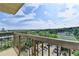 This balcony features a metal railing and a view of a parking lot, park, tennis courts and the neighborhood at 795 Hammond Dr # 1108, Atlanta, GA 30328