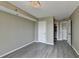 This bedroom features gray floors, neutral walls, and a view into a hallway with multiple doors at 795 Hammond Dr # 1108, Atlanta, GA 30328