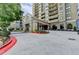 Circular driveway leading up to the condominium entrance with covered parking at 795 Hammond Dr # 1108, Atlanta, GA 30328