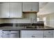 Modern kitchen featuring granite countertops, stainless steel dishwasher and gray tone cabinets at 795 Hammond Dr # 1108, Atlanta, GA 30328