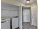 Convenient laundry area features a stacked washer and dryer unit in the hallway at 795 Hammond Dr # 1108, Atlanta, GA 30328