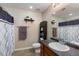 Well-lit bathroom with a neutral color scheme, shower-tub combination, and functional shelving at 805 Pleasant Hill Nw Rd # 231, Lilburn, GA 30047