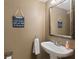 Quaint half-bath with a playful sign, soft towel, pedestal sink, and bright, clean features at 805 Pleasant Hill Nw Rd # 231, Lilburn, GA 30047