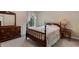 Cozy bedroom with dark wood furniture, neutral walls, and natural light from a window at 805 Pleasant Hill Nw Rd # 231, Lilburn, GA 30047