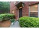 Charming brick home featuring a front door, lush landscaping, and a cozy, inviting entry at 805 Pleasant Hill Nw Rd # 231, Lilburn, GA 30047