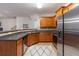 Cozy kitchen with wood cabinets, stainless steel appliances, and a decorative backsplash at 805 Pleasant Hill Nw Rd # 231, Lilburn, GA 30047