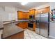 Well-lit kitchen with stainless steel appliances, dark countertops, and wood cabinets at 805 Pleasant Hill Nw Rd # 231, Lilburn, GA 30047