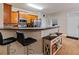 Fully equipped kitchen features a breakfast bar, stainless steel appliances, and wood floors at 805 Pleasant Hill Nw Rd # 231, Lilburn, GA 30047