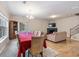 Open-concept living room features hardwood floors, a fireplace, and a large dining table at 805 Pleasant Hill Nw Rd # 231, Lilburn, GA 30047