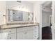 Bright bathroom featuring granite countertops, white cabinets and a large mirror at 1230 Piedmont Ne Ave # 405, Atlanta, GA 30309