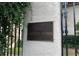 Close-up of the building nameplate affixed to a pillar on the right side of the entry gate at 1230 Piedmont Ne Ave # 405, Atlanta, GA 30309