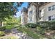 Side angle of white building showing mature tree and shrubbery at 1230 Piedmont Ne Ave # 405, Atlanta, GA 30309