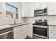 Granite counters with white cabinets and stainless steel appliances in updated kitchen at 1230 Piedmont Ne Ave # 405, Atlanta, GA 30309