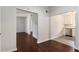 Open concept living space with dark hardwood floors and a glimpse of the updated kitchen at 1230 Piedmont Ne Ave # 405, Atlanta, GA 30309