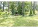 Lush backyard view with mature trees and a small shed, offering a serene and private outdoor space at 5400 Francis Ave, Stone Mountain, GA 30087