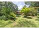 Lush backyard featuring mature trees and well-maintained landscaping with access to a cozy back porch at 5400 Francis Ave, Stone Mountain, GA 30087
