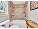 Well lit bathroom features a tiled shower and tub with built-in shelving at 5400 Francis Ave, Stone Mountain, GA 30087