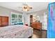 Bedroom featuring hardwood floors, a ceiling fan, a closet, and built-in storage at 5400 Francis Ave, Stone Mountain, GA 30087