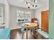 Dining room featuring hardwood floors, large windows, a modern light fixture, and natural light at 5400 Francis Ave, Stone Mountain, GA 30087