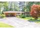 Brick home with a carport features a spacious driveway and a well-maintained front yard at 5400 Francis Ave, Stone Mountain, GA 30087