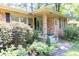 Charming home with inviting porch, brick facade, and mature landscaping creating great curb appeal at 5400 Francis Ave, Stone Mountain, GA 30087