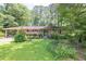 Charming brick ranch home with lush front yard and mature trees creating great curb appeal at 5400 Francis Ave, Stone Mountain, GA 30087