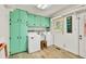 Efficient laundry room features ample storage, washer, dryer, sink and bright light at 5400 Francis Ave, Stone Mountain, GA 30087