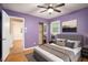 Cozy bedroom featuring hardwood floors and a gray bed with decorative pillows at 890 Oriole Se Ln, Marietta, GA 30067