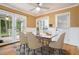 Bright dining room with french doors to screened porch, white wainscoting, modern table with seating for six at 890 Oriole Se Ln, Marietta, GA 30067