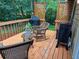 This cozy back deck features two rocking chairs, a gas grill and plenty of lush foliage at 4801 Deer Chase, Powder Springs, GA 30127