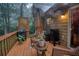 Cozy back deck with wicker furniture, grill, smoker and charming lattice accents, ideal for outdoor relaxation and entertainment at 4801 Deer Chase, Powder Springs, GA 30127