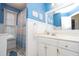 Cheerful blue bathroom features a shower-tub combo, and white vanity at 4801 Deer Chase, Powder Springs, GA 30127