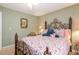 Relaxing bedroom features decoratively patterned bedding, and an ornate iron headboard at 4801 Deer Chase, Powder Springs, GA 30127