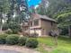 Two-story house nestled among trees with stone accents and a two-car garage at 4801 Deer Chase, Powder Springs, GA 30127