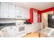 Cozy kitchen with pantry, white cabinets, and an open floor plan at 4801 Deer Chase, Powder Springs, GA 30127
