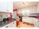 Bright kitchen featuring white cabinets, black countertops, and stainless steel appliances at 4801 Deer Chase, Powder Springs, GA 30127