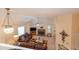 Bright living room features a stone fireplace, ceiling fan, plush sofas, and an eye-catching chandelier at 4801 Deer Chase, Powder Springs, GA 30127