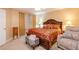 Cozy bedroom with a luxurious bed dressed in red and gold, comfortable seating, and soft lighting at 4801 Deer Chase, Powder Springs, GA 30127