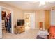 Bedroom with a walk-in closet, open bathroom door, and a TV stand, offering convenience and style at 4801 Deer Chase, Powder Springs, GA 30127