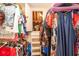 Organized walk-in closet with ample hanging space and a glimpse into an unfinished attic at 4801 Deer Chase, Powder Springs, GA 30127