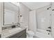 Updated bathroom features granite countertops, a modern vanity, and a shower-tub combo at 1010 Fendley St, Woodstock, GA 30188