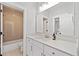 The bathroom features neutral walls, a large mirror, and white cabinets at 1010 Fendley St, Woodstock, GA 30188