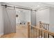 Spacious bedroom featuring barn doors, hardwood floors, and a cute crib at 1010 Fendley St, Woodstock, GA 30188