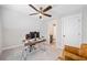 This bedroom has a ceiling fan, a desk, and an adjacent bathroom at 1010 Fendley St, Woodstock, GA 30188