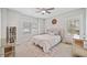 Bright bedroom featuring two windows, a ceiling fan, and a plush rug at 1010 Fendley St, Woodstock, GA 30188