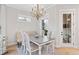 Elegant dining area with a decorative chandelier and lots of natural light at 1010 Fendley St, Woodstock, GA 30188