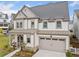 Charming two-story home with a two-car garage, landscaped yard, and covered porch at 1010 Fendley St, Woodstock, GA 30188