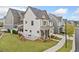 View of home's side yard with lawn and view of other homes in neighborhood at 1010 Fendley St, Woodstock, GA 30188